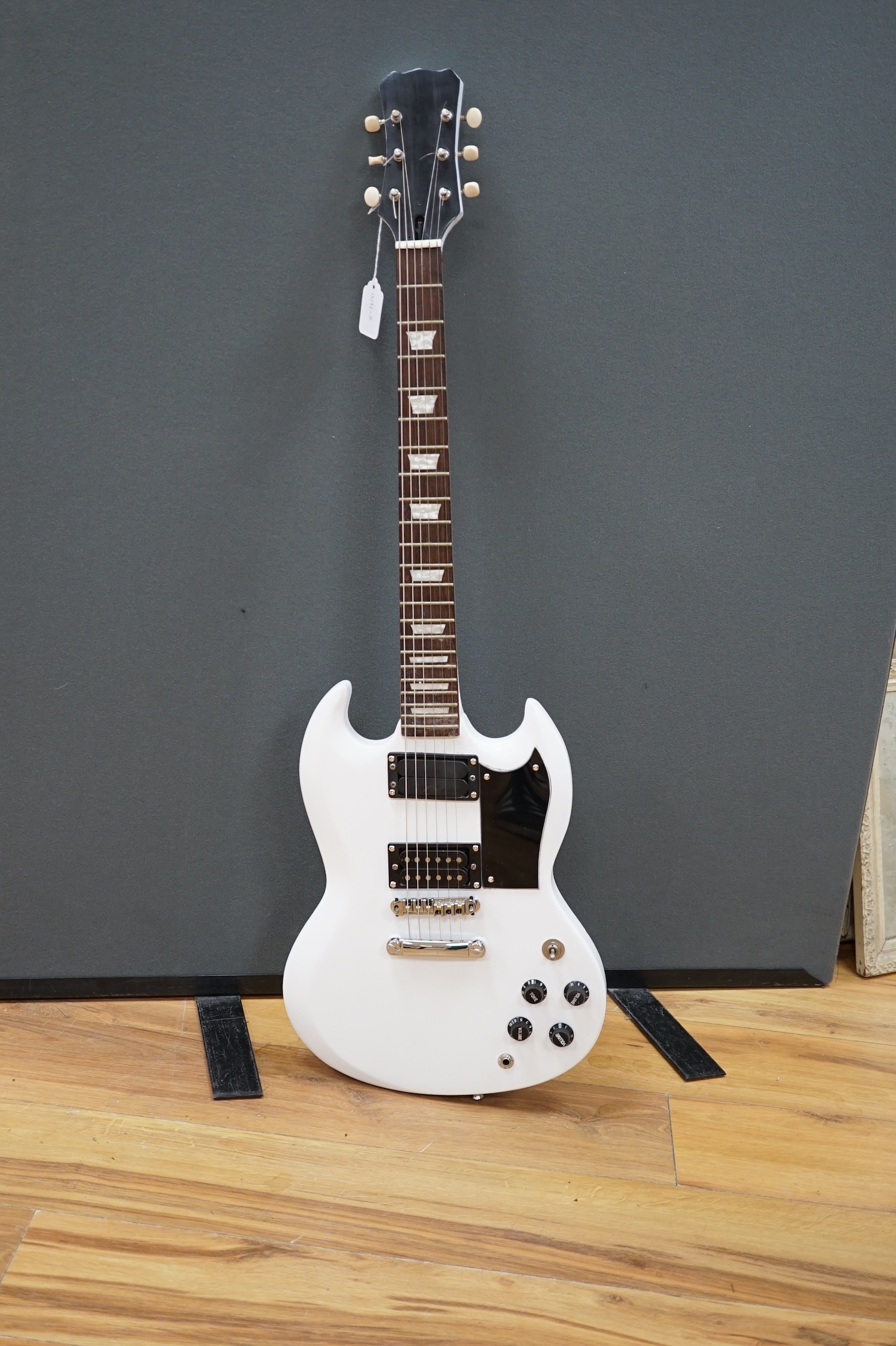 A white painted electric six string guitar